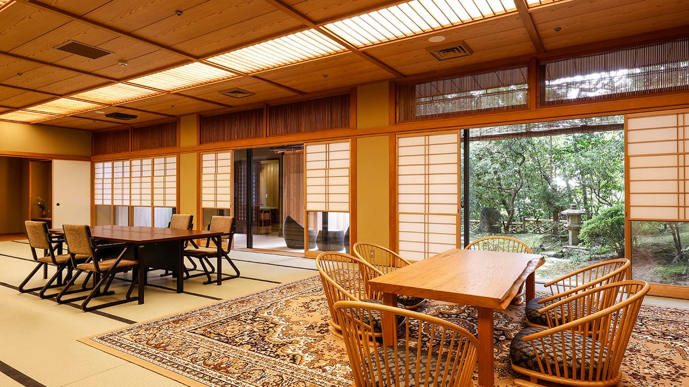 Spacious tatami suite with sofas and a dining area at Ginsuiso Choraku
