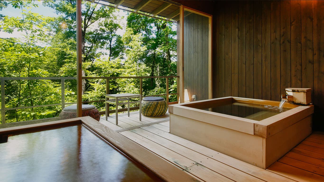Private cypress soaking tub on a deck overlooking the forest at Ginsuiso Choraku