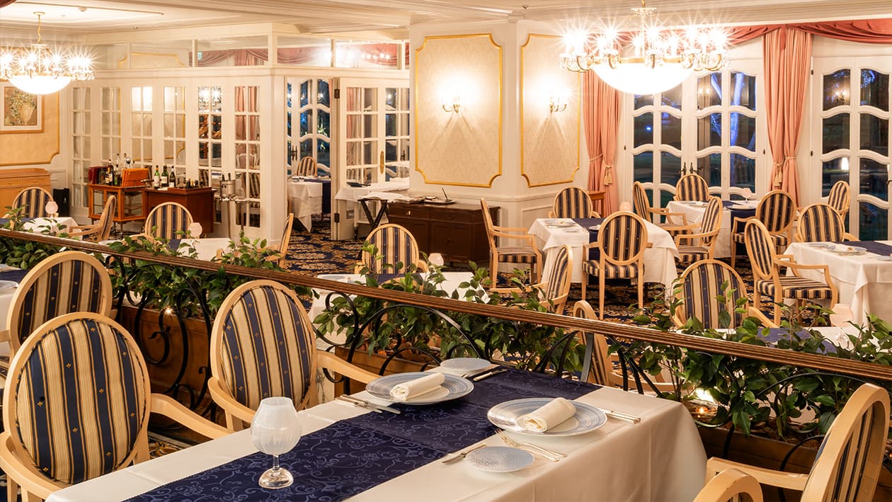 Le Trianon French restaurant dining room with chandeliers and set tables in the evening at Takanawa Hanakohro Tokyo