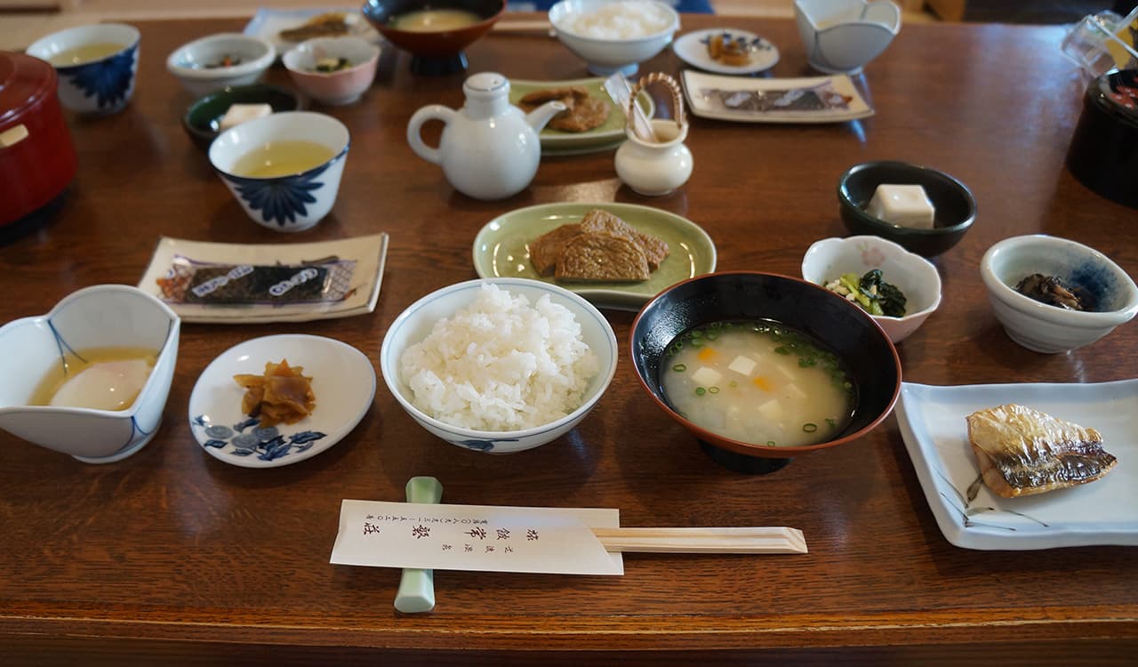 Traditional Japanese breakfast set with rice, miso soup, grilled fish and small dishes at Tokiwaso, Dogo Onsen