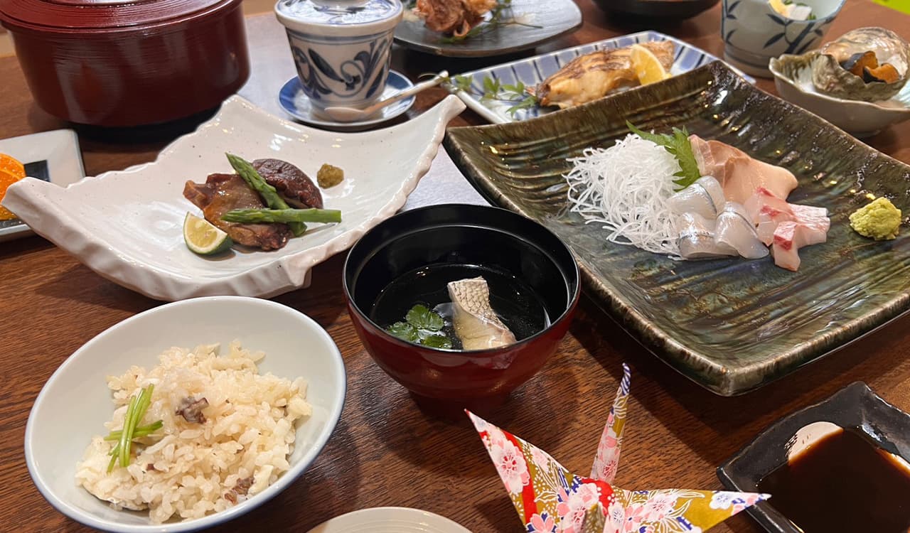 Kaiseki dinner spread with sea bream sashimi, simmered dishes and seasoned rice at Tokiwaso, Dogo Onsen