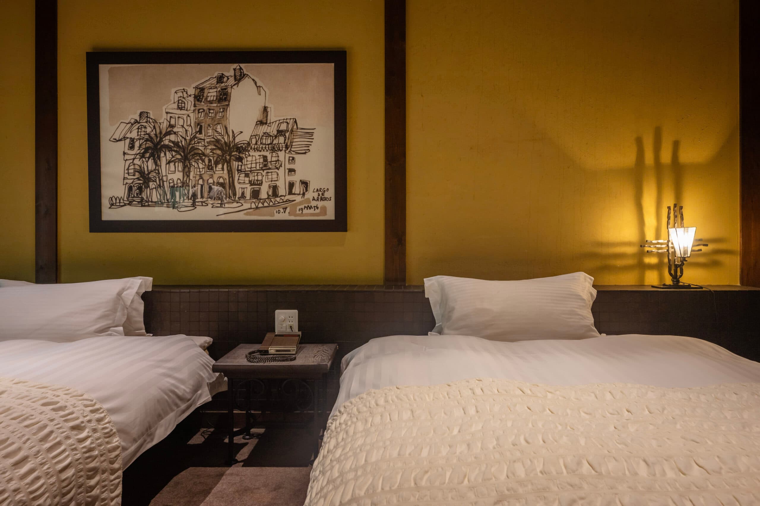 Second classic twin-bed villa bedroom with retro furnishings and soft evening light at Gosho Bessho