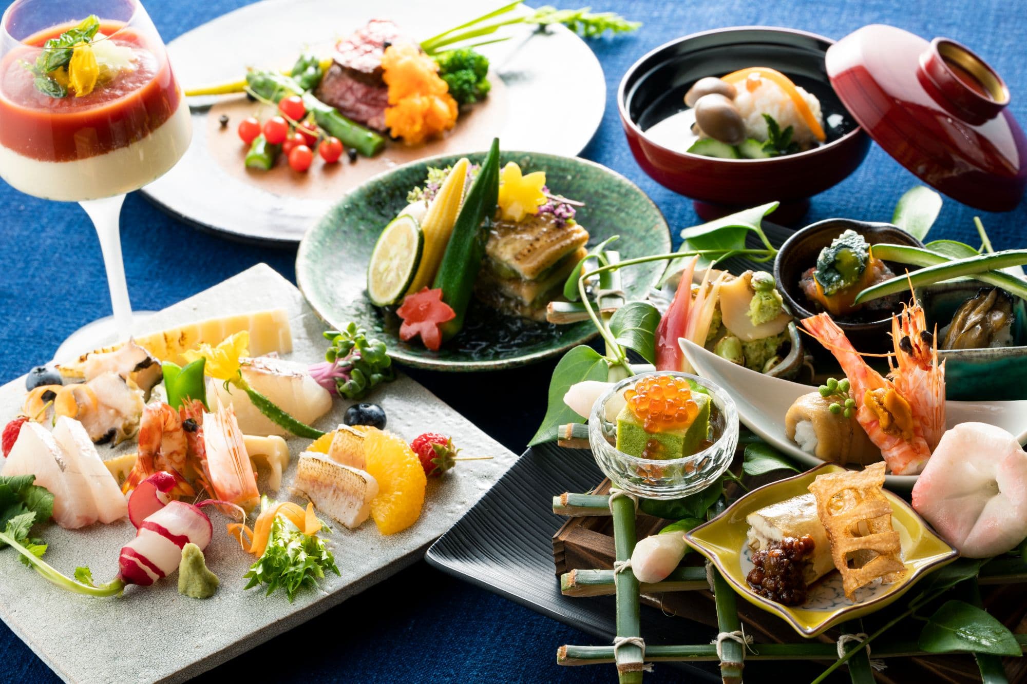 Seasonal kaiseki dinner spread at IBUKU with multiple plated courses of sashimi, simmered dishes and appetizers