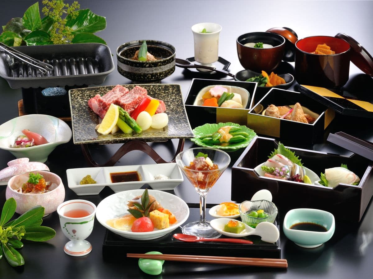 Lavish multi-course kaiseki dinner spread with grilled wagyu, sashimi and seasonal small dishes