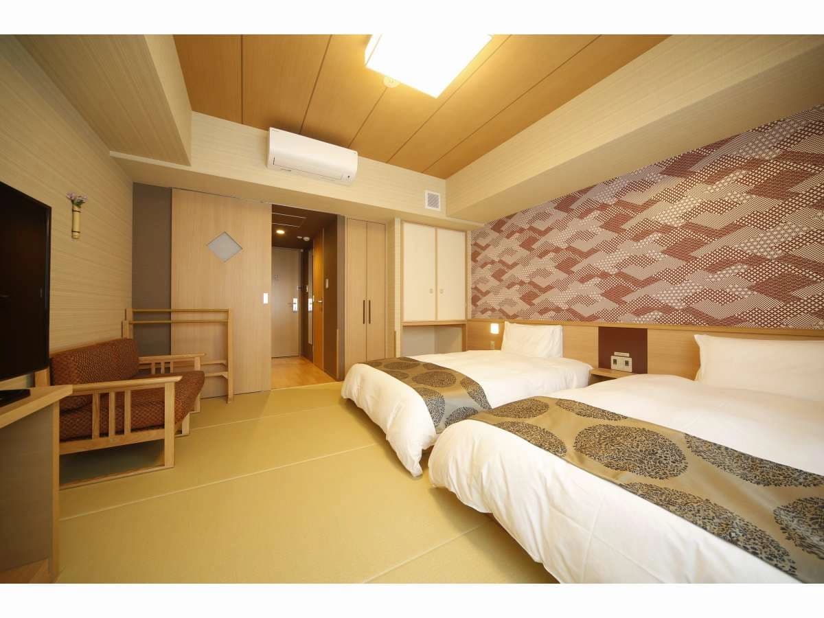 Twin guest room at Onyado Nono Nara with two beds, tatami flooring and patterned accent wall