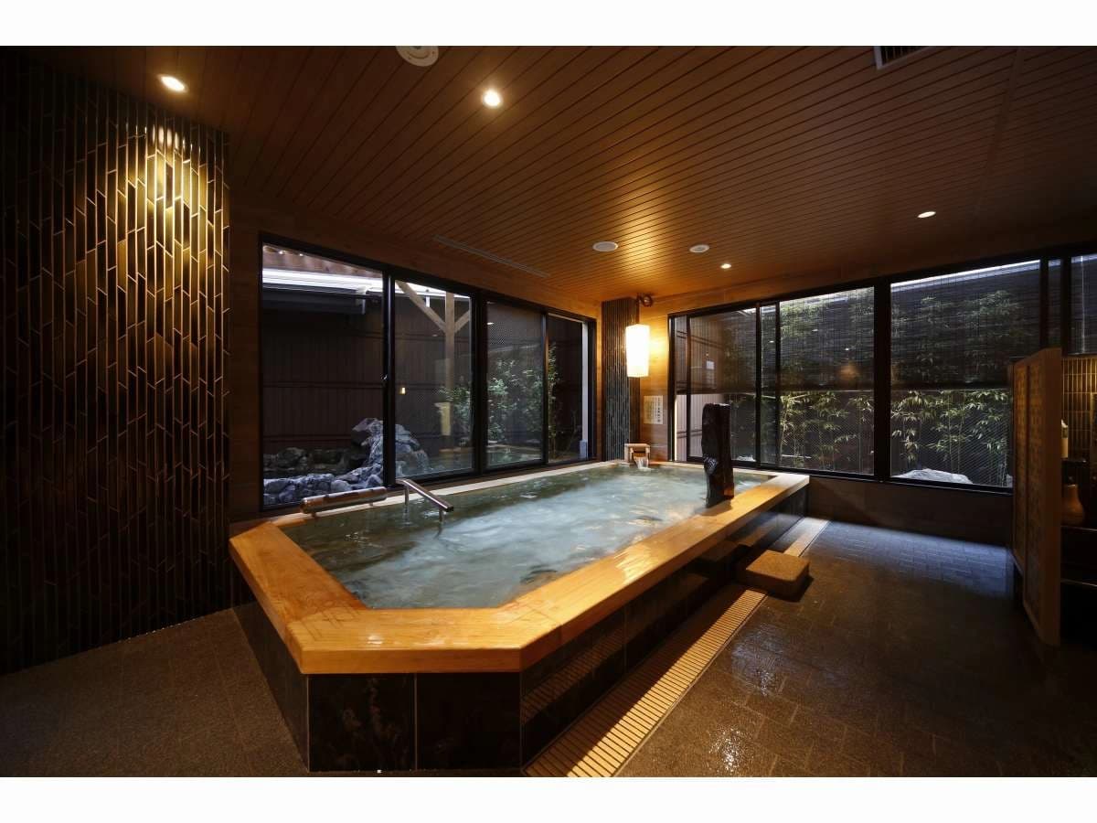 Indoor natural hot spring bath at Onyado Nono Nara with wooden tub and garden-facing windows