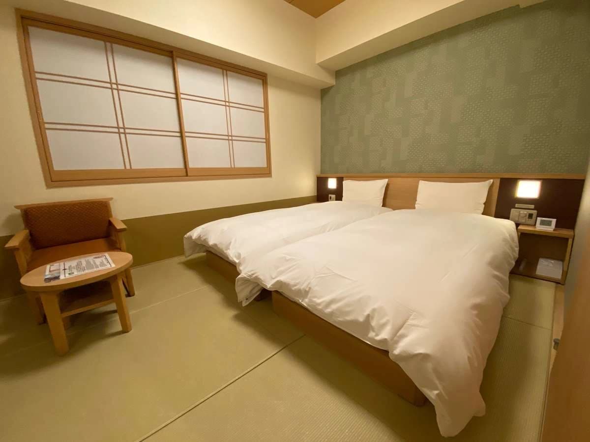 Double guest room at Onyado Nono Nara with low bed, tatami flooring and armchair