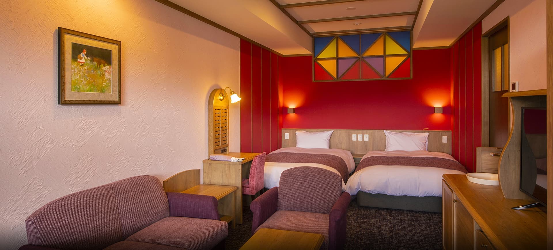 Storybook-themed twin guest room at La Vista Kusatsu Hills with a deep-red feature wall, stained-glass panel and framed fairy-tale artwork