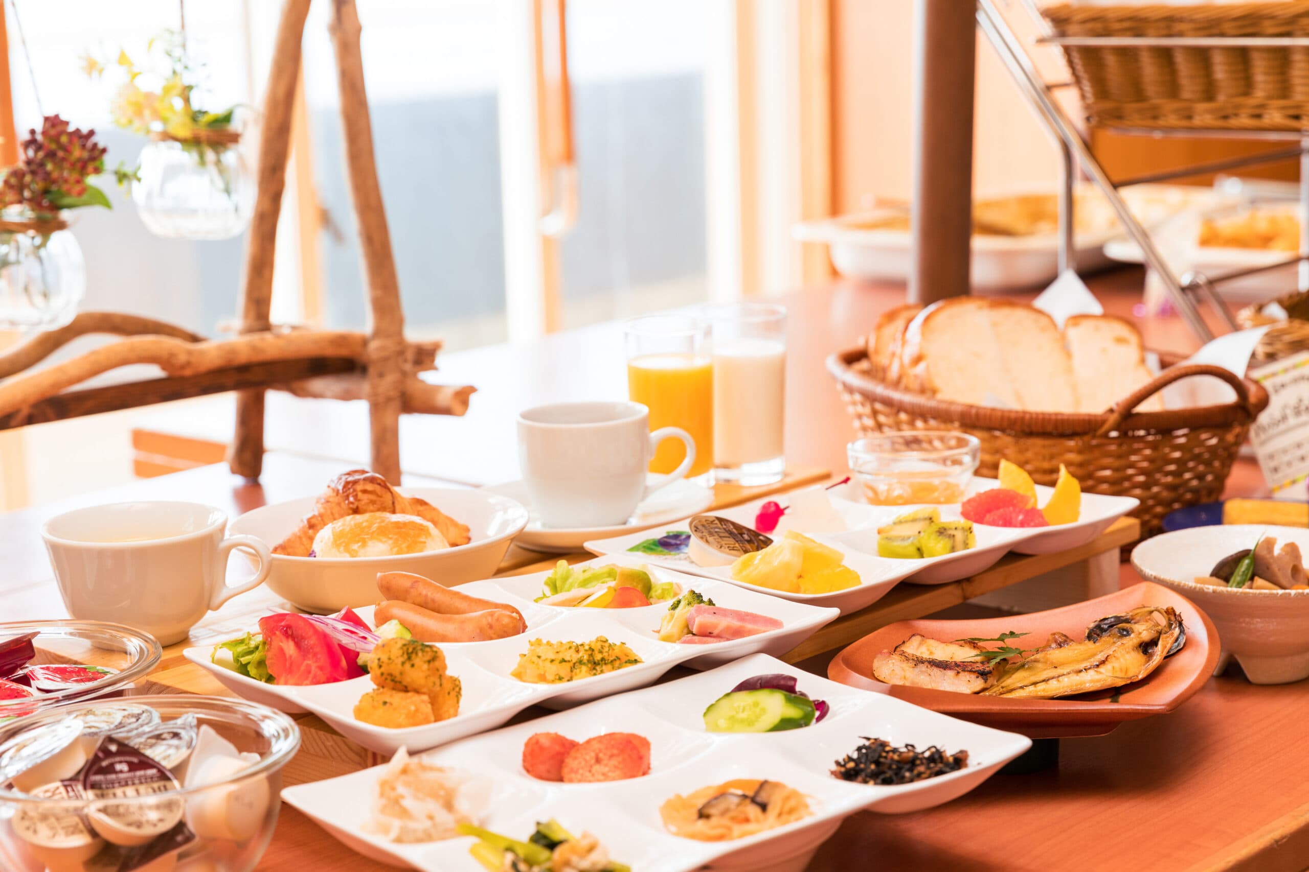 Japanese breakfast spread with grilled fish, side dishes and fresh juice at Inatoriso, Inatori Onsen, Izu