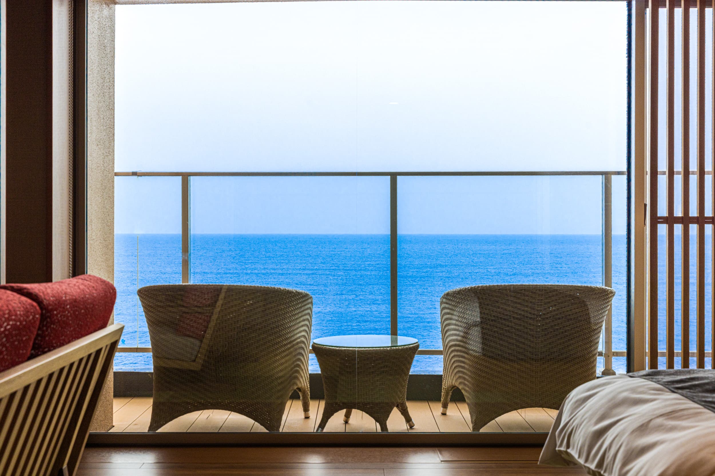 Guest-room terrace at Inatoriso with rattan chairs overlooking the deep-blue sea, Inatori Onsen, Izu