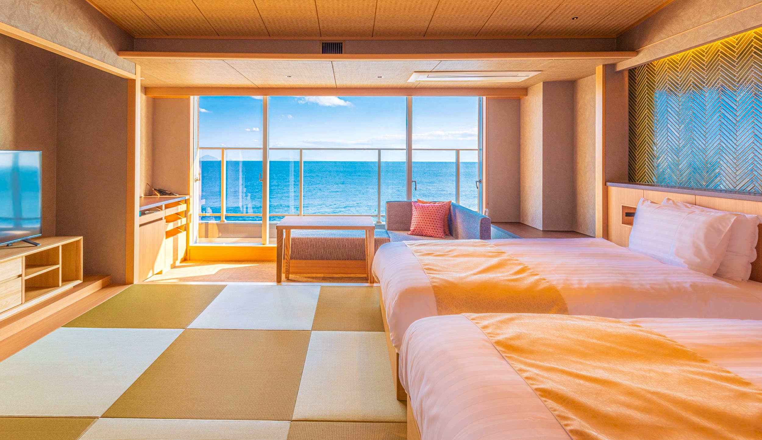 Twin-bed tatami guest room at Inatoriso with checkerboard floor and ocean-view balcony, Inatori Onsen, Izu