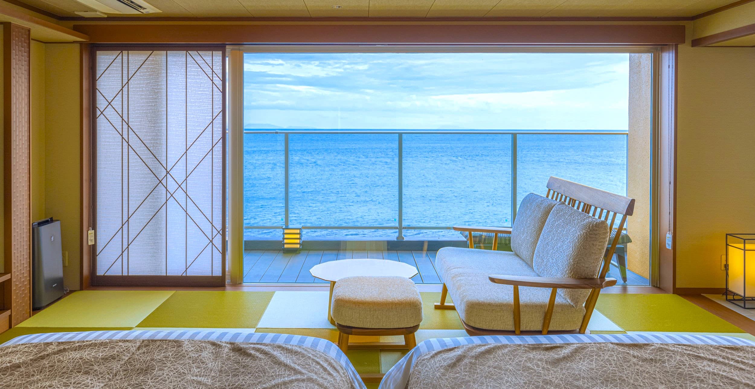 Modern Japanese-Western guest room at Inatoriso with sofa, beds and ocean view, Inatori Onsen, Izu