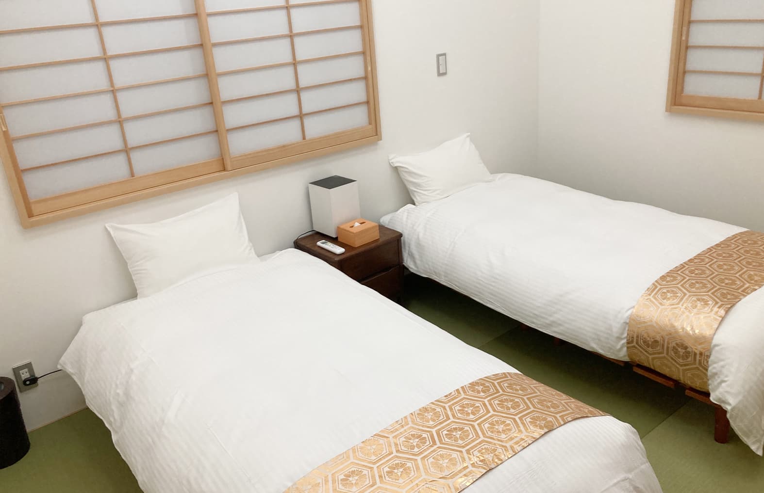 Japanese-Western twin bedroom at Ito Ryokan Tokyo with shoji screens and tatami flooring