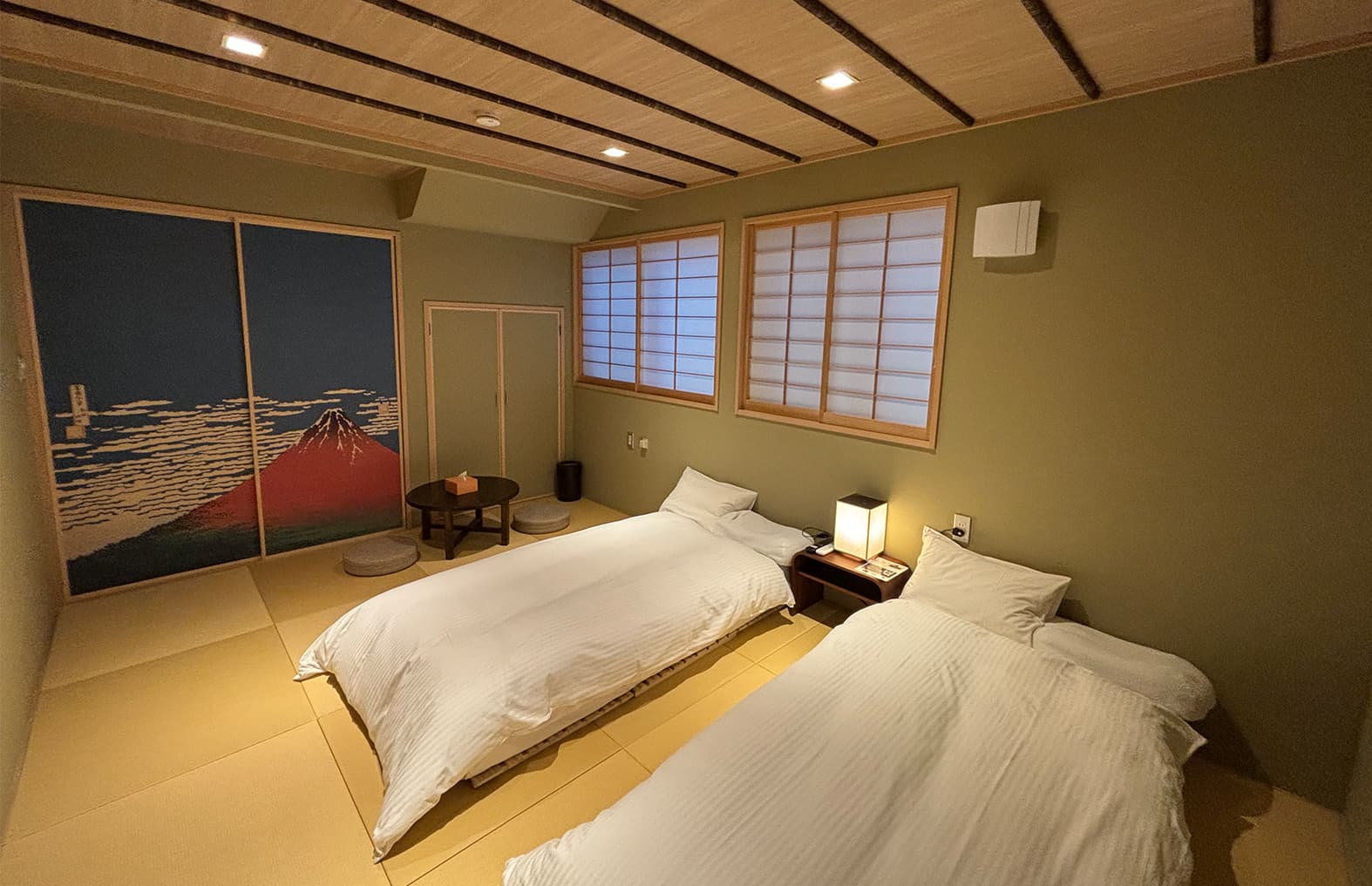 Tatami guest room at Ito Ryokan Tokyo with twin futons and Red Fuji ukiyo-e fusuma art