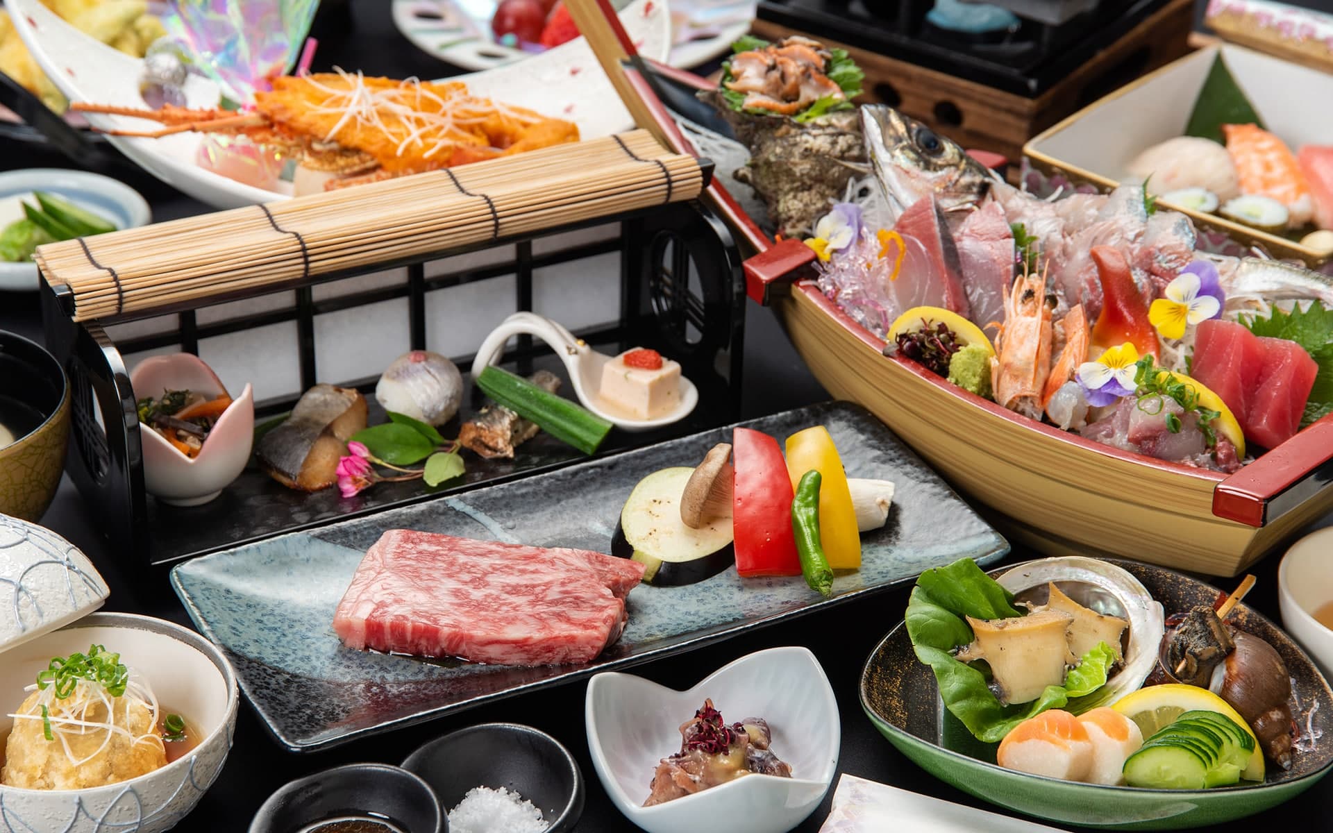 Multi-course kaiseki dinner with wagyu beef and a boat of fresh sashimi served at Ibusuki Kaijo Hotel