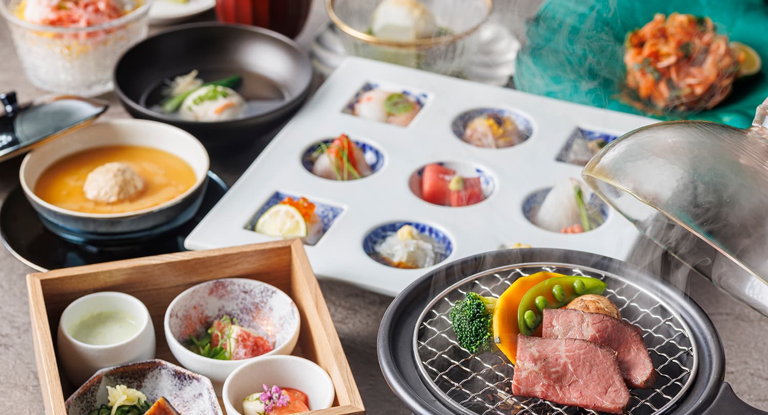 Japanese kaiseki dinner spread at Kamenoi Hotel Atami with sashimi tray, grilled wagyu and small dishes