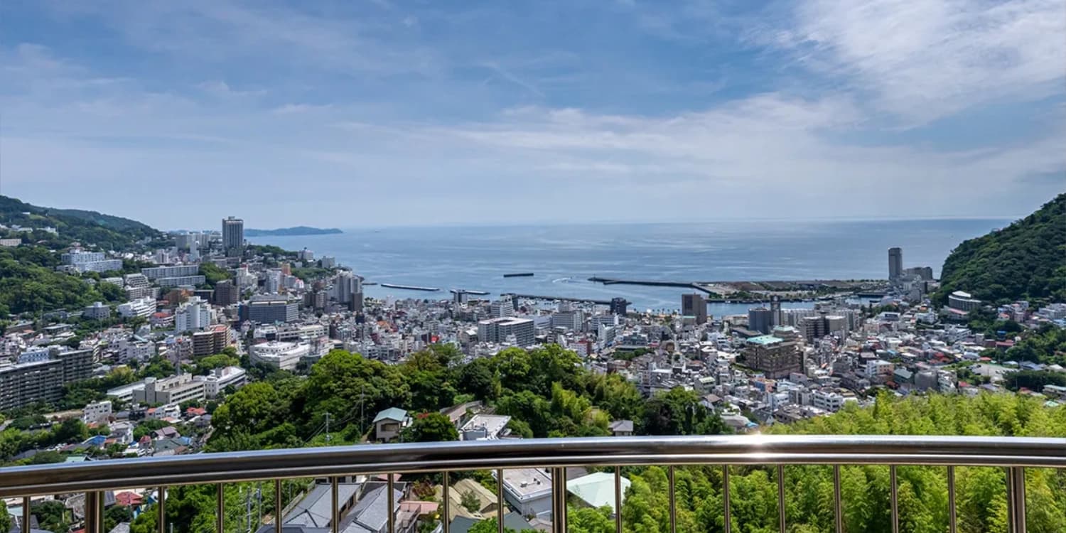 Panoramic view from Kamenoi Hotel Atami over the town rooftops and Sagami Bay coastline
