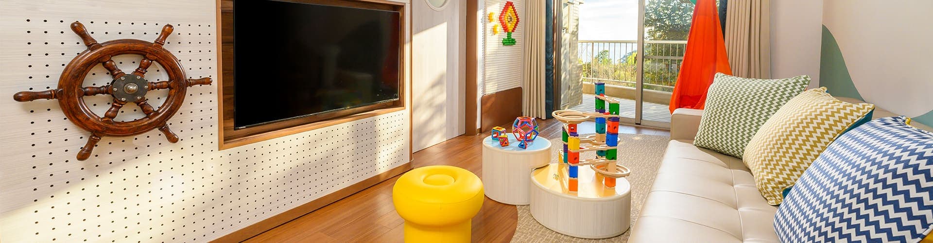 Playful kids-themed guest room at Kamenoi Hotel Atami with nautical decor, soft toys and a balcony