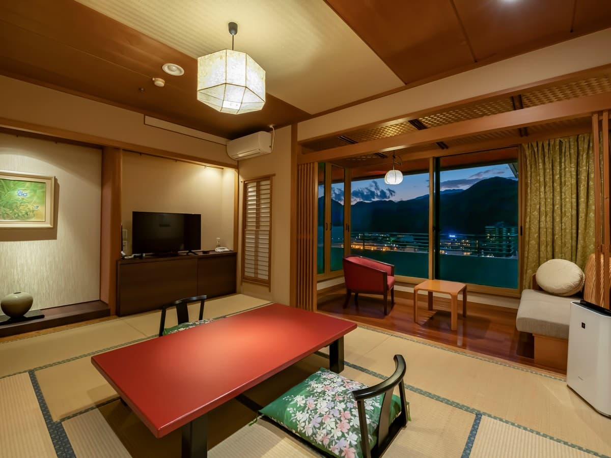 Japanese-style guest room with a low table and evening mountain view