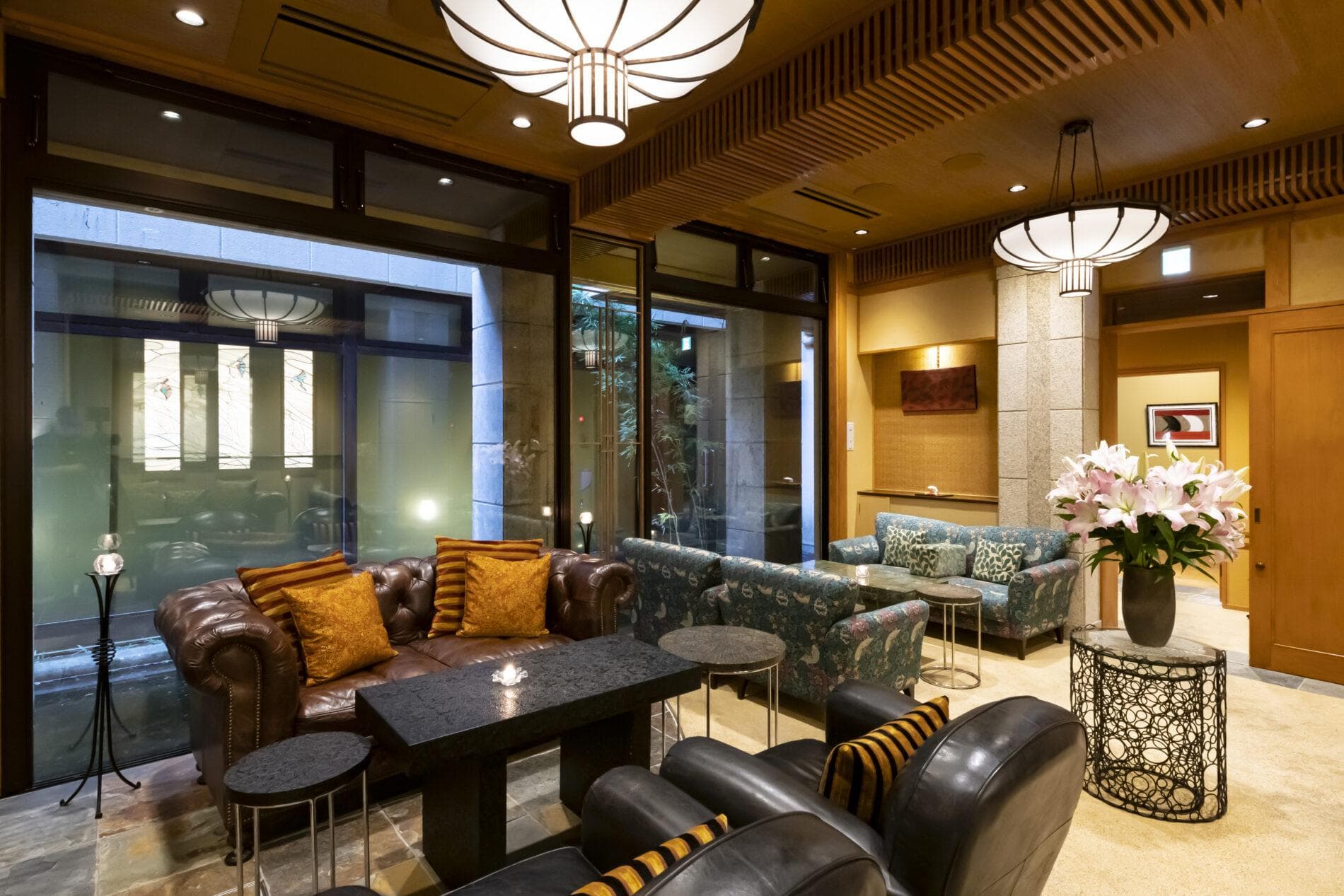 Lobby lounge with leather sofas, hanging lanterns and an inner courtyard view at Kinugawa Grand Hotel Yume no Toki