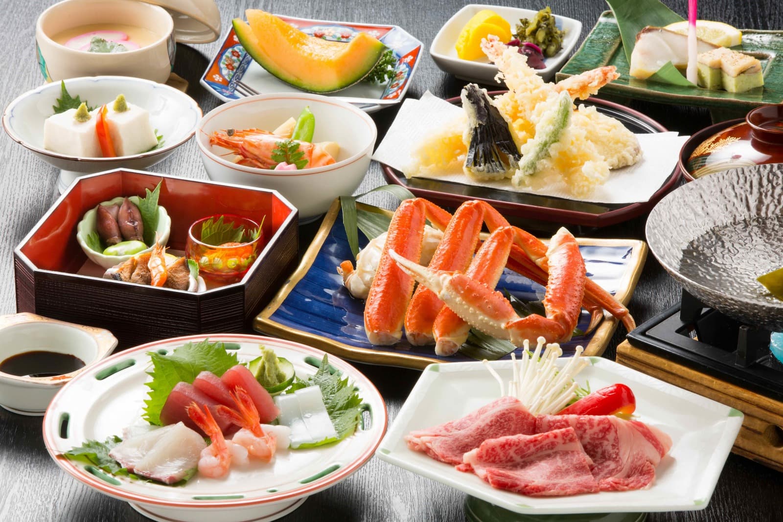 Full kaiseki dinner table with crab, tempura and sashimi at Mikuniya