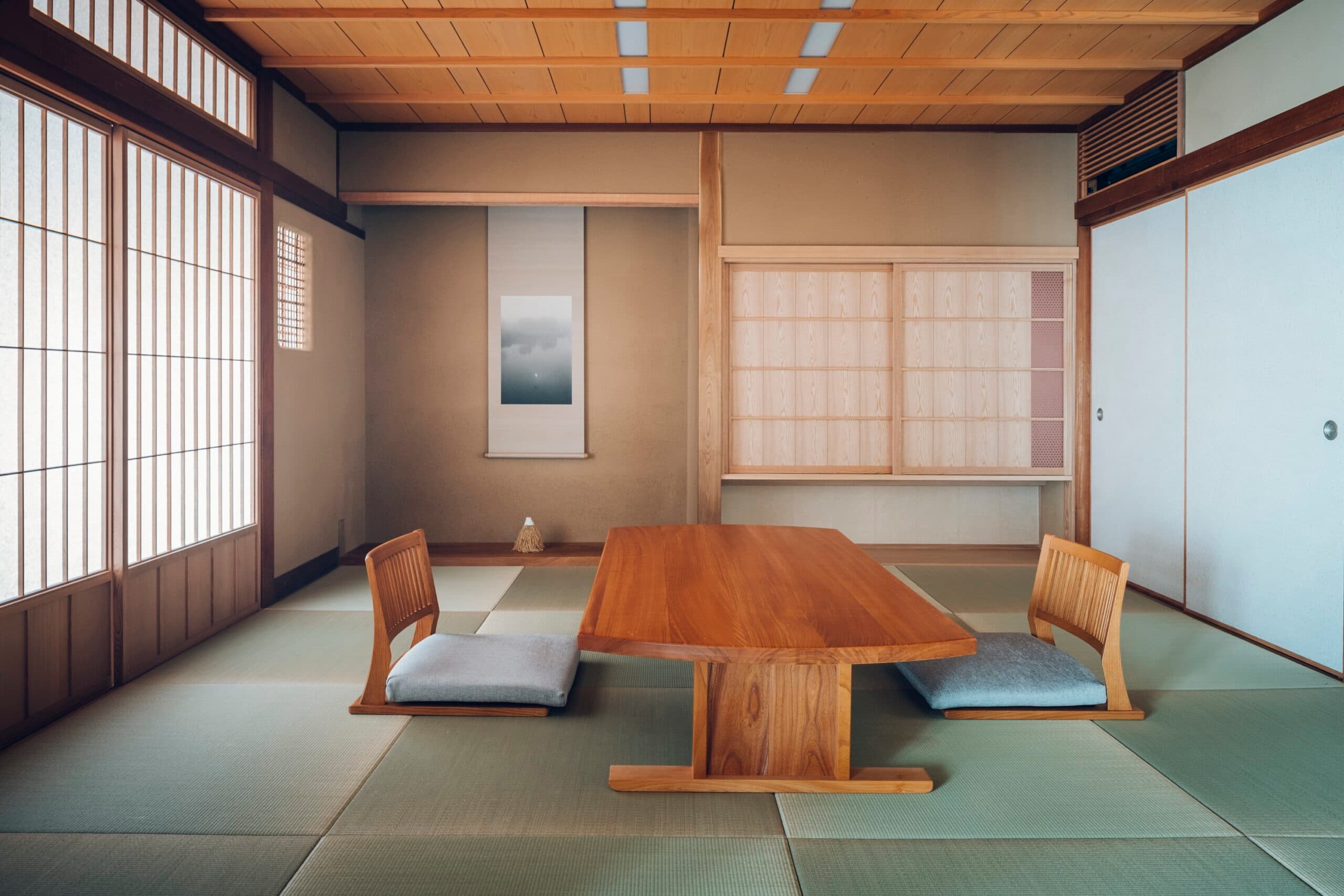 Spacious tatami guest room with low wooden table at Mikuniya