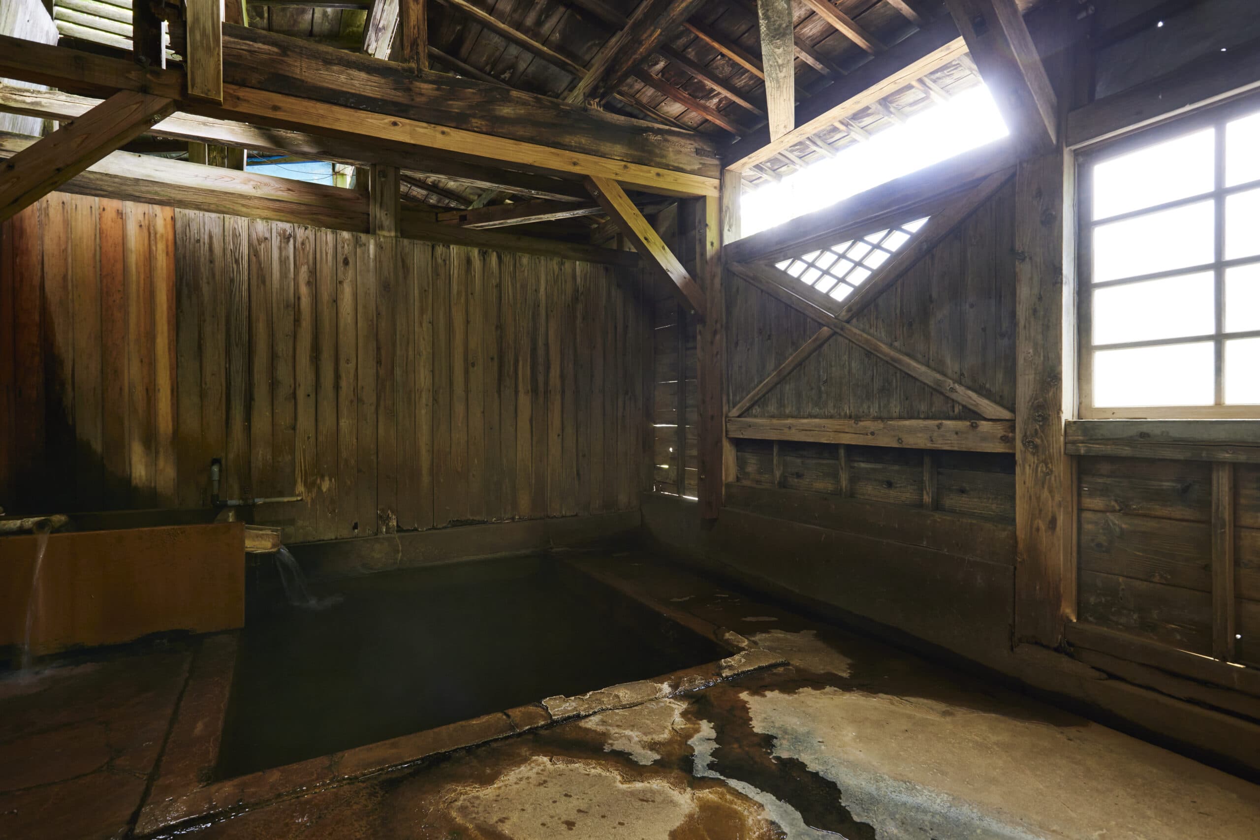 Rustic wooden indoor hot spring bathhouse