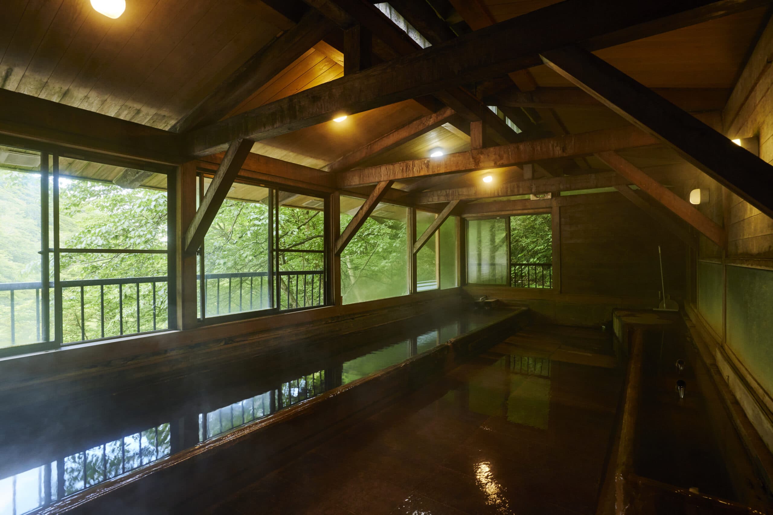 The large wooden swimming bath hall with mountain views