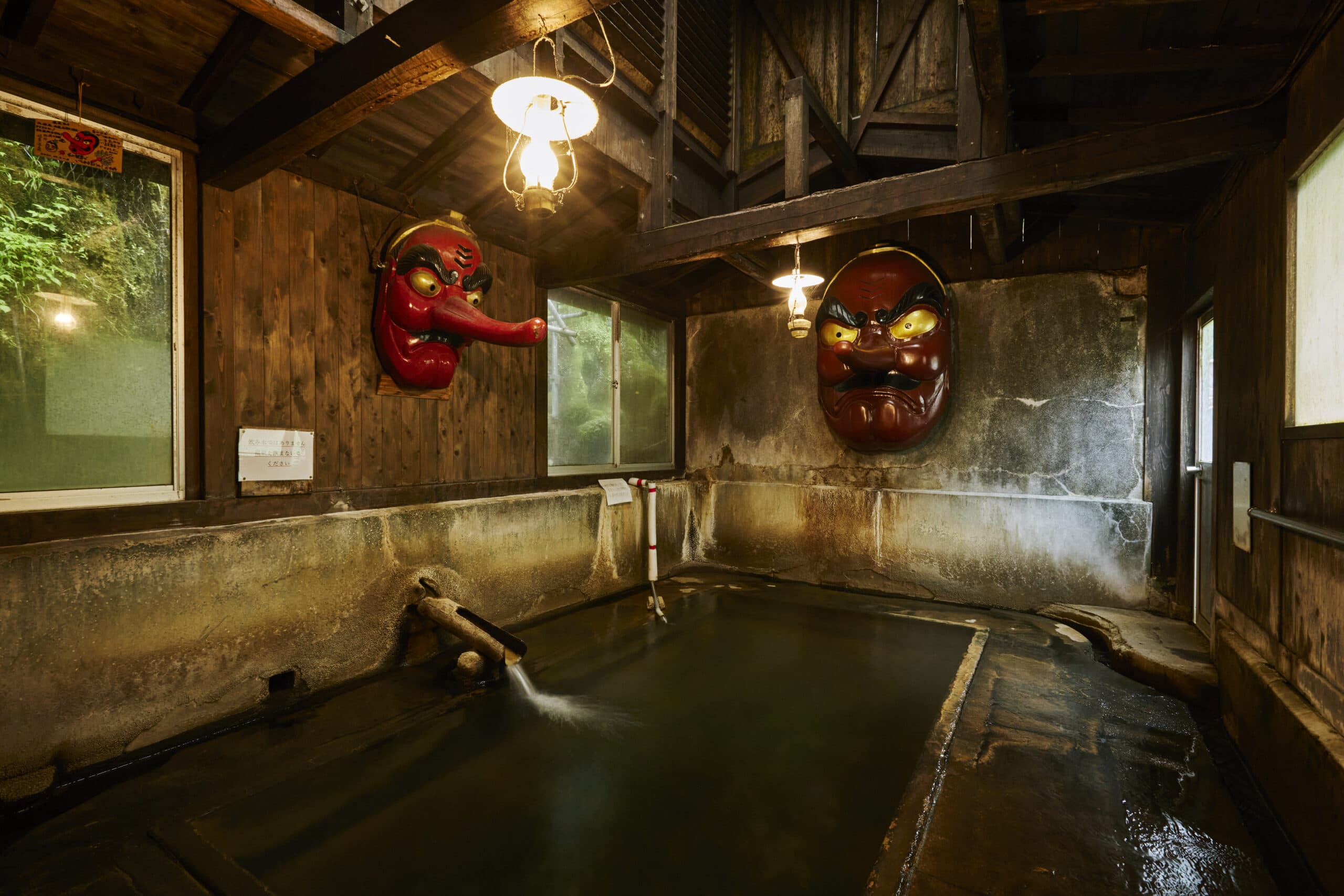 Tengu-no-yu bath with two giant red Tengu masks on the wall
