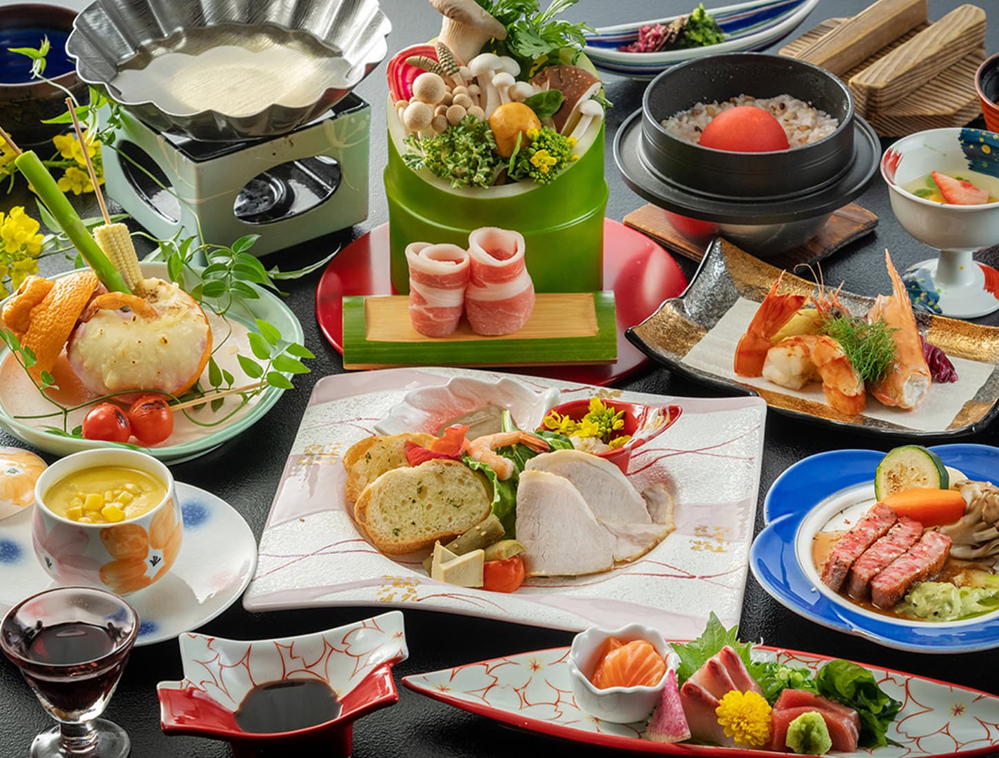 Multi-course kaiseki dinner at Kiyonoya with sashimi, grilled meat, tempura and seasonal small dishes on colorful plates