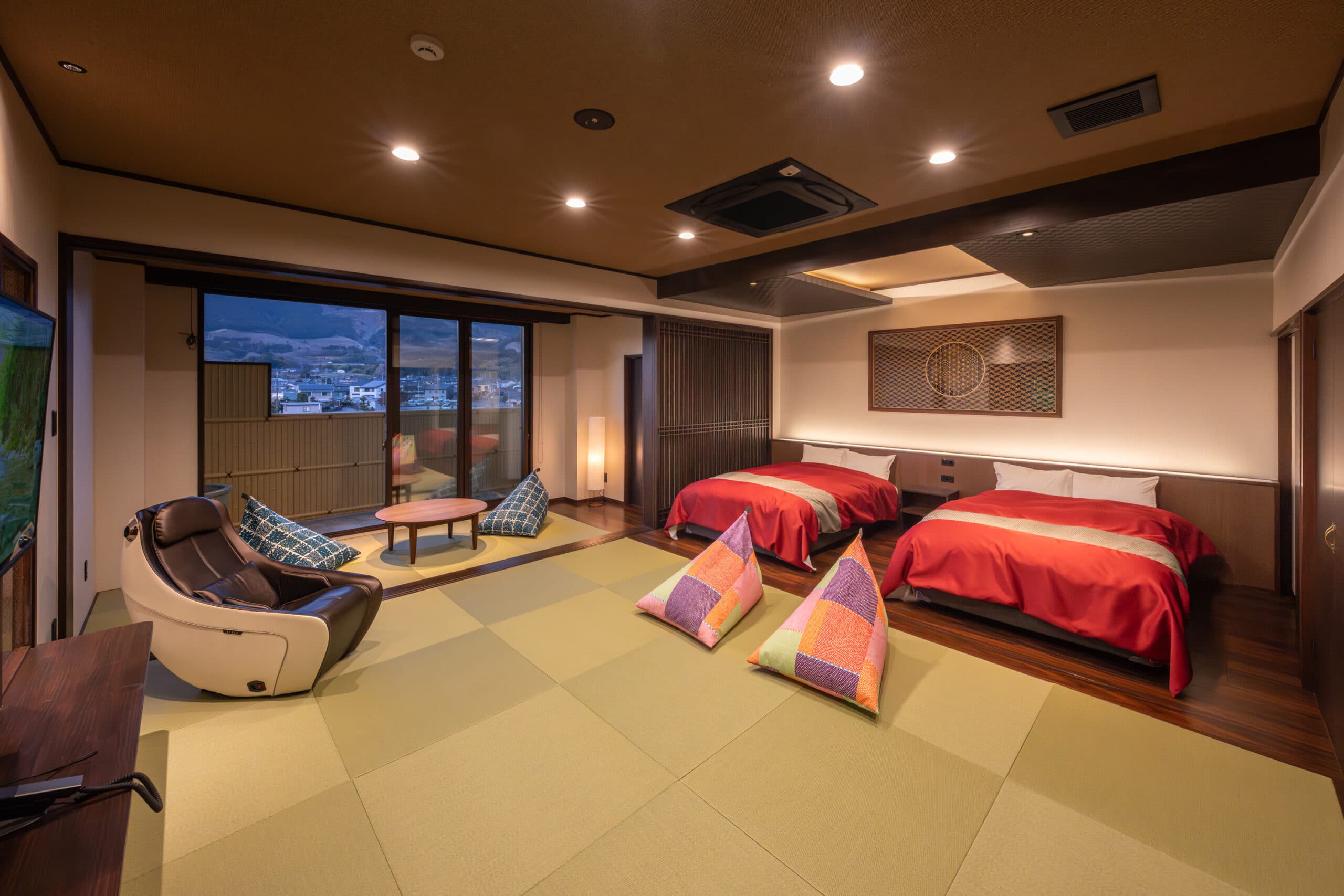 Premium Yuzen guest room at Kiyonoya with twin low beds, tatami flooring and a river view at dusk