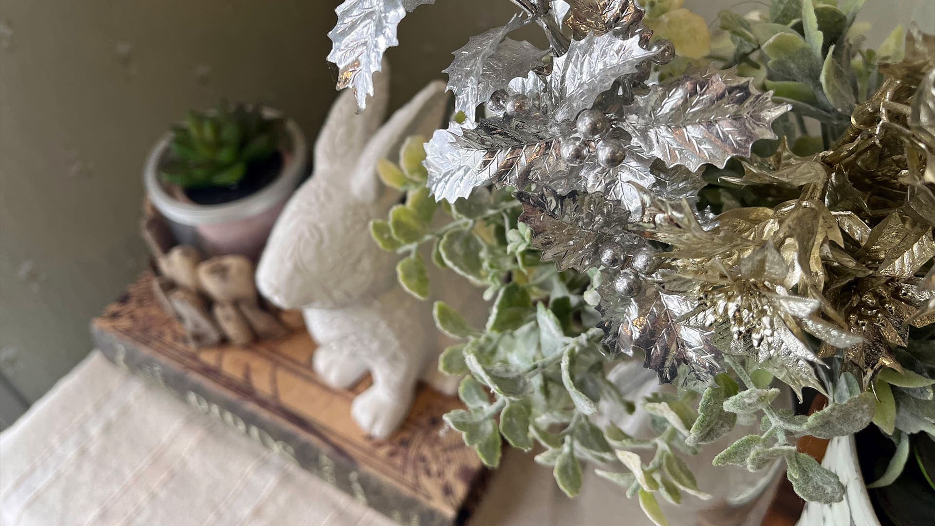 Interior decor still life with a ceramic rabbit, succulent and silver foliage at Vent Vert