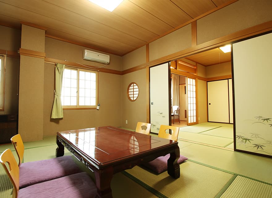 Spacious tatami room with a round window and adjoining second room