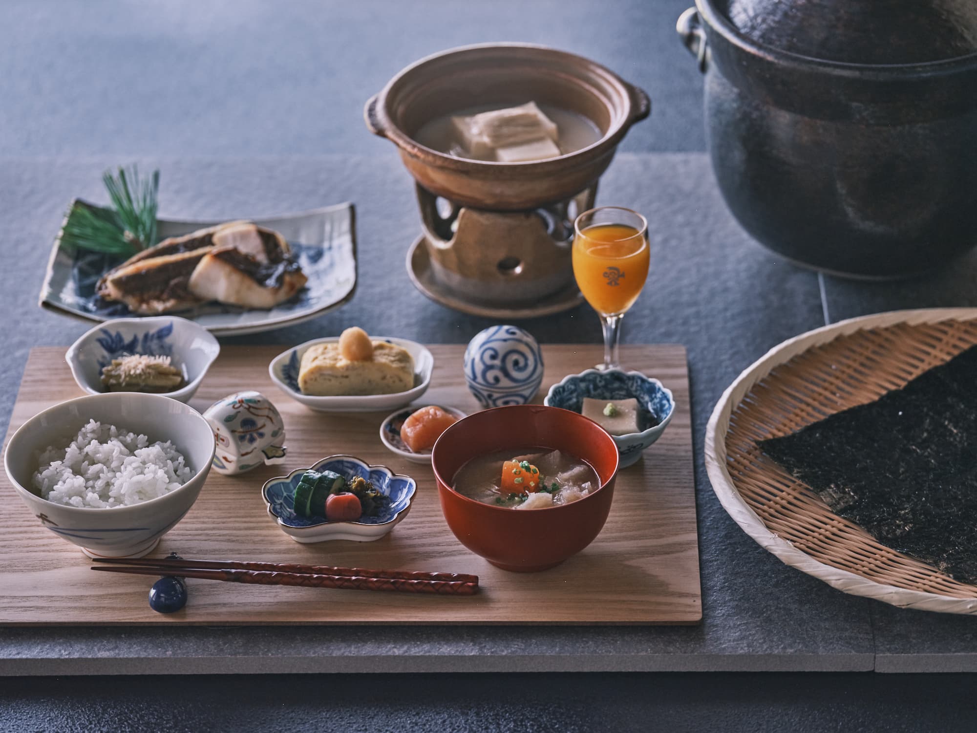 Japanese breakfast set at Ohana with grilled fish, rice, miso soup, simmered tofu hotpot and small side dishes in blue-and-white porcelain