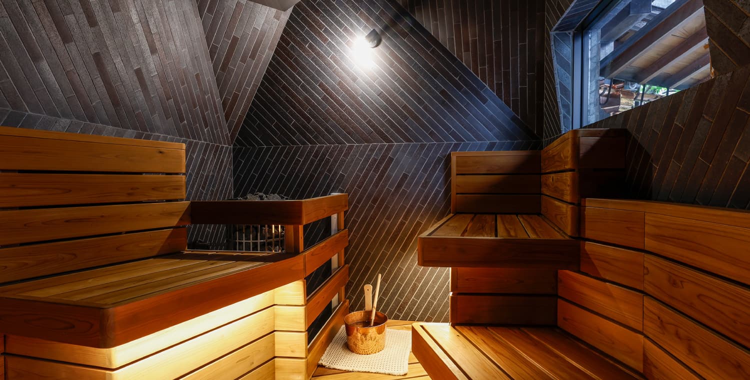 Wood-clad sauna room at Ryokufukaku with warm bench lighting