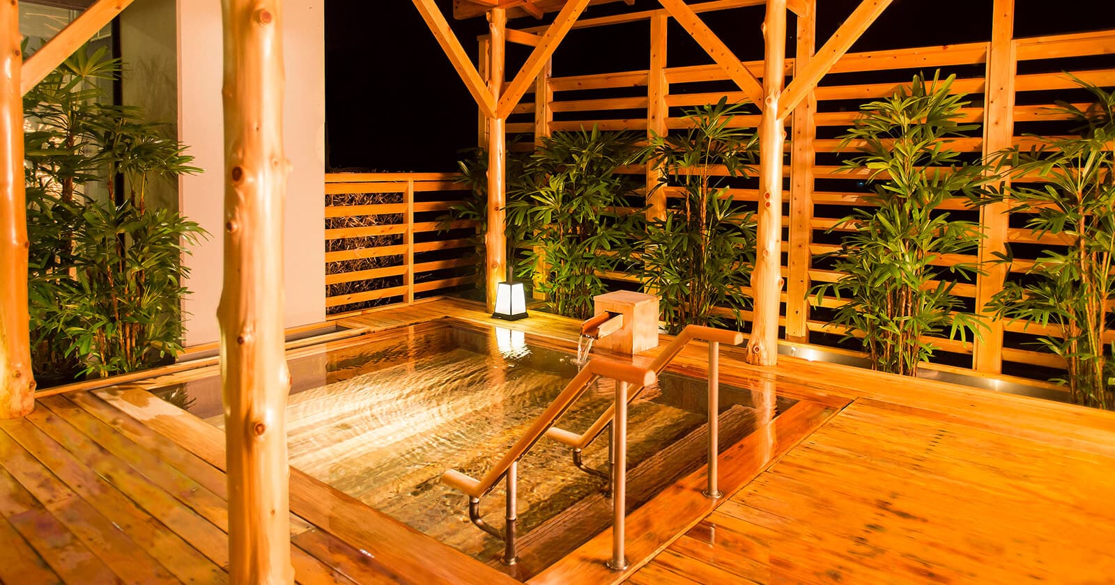 Wooden open-air bath deck overlooking the river