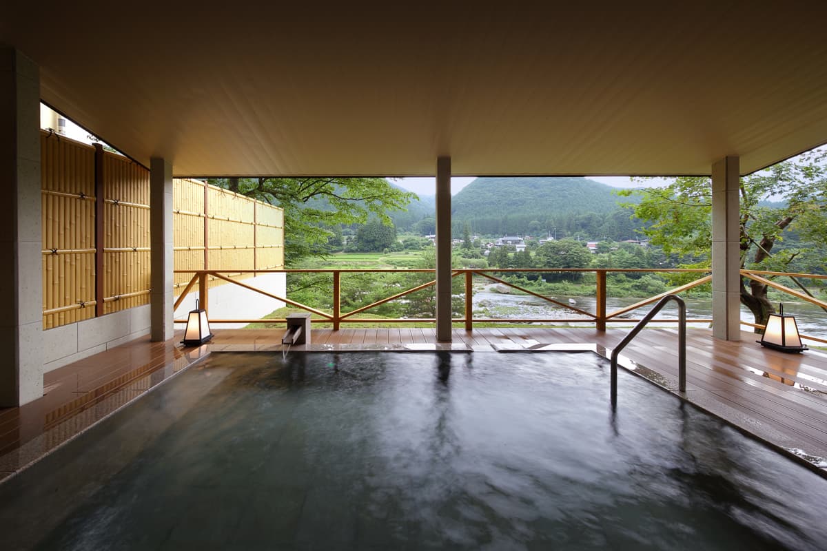 Indoor bath with panoramic valley view through wide windows