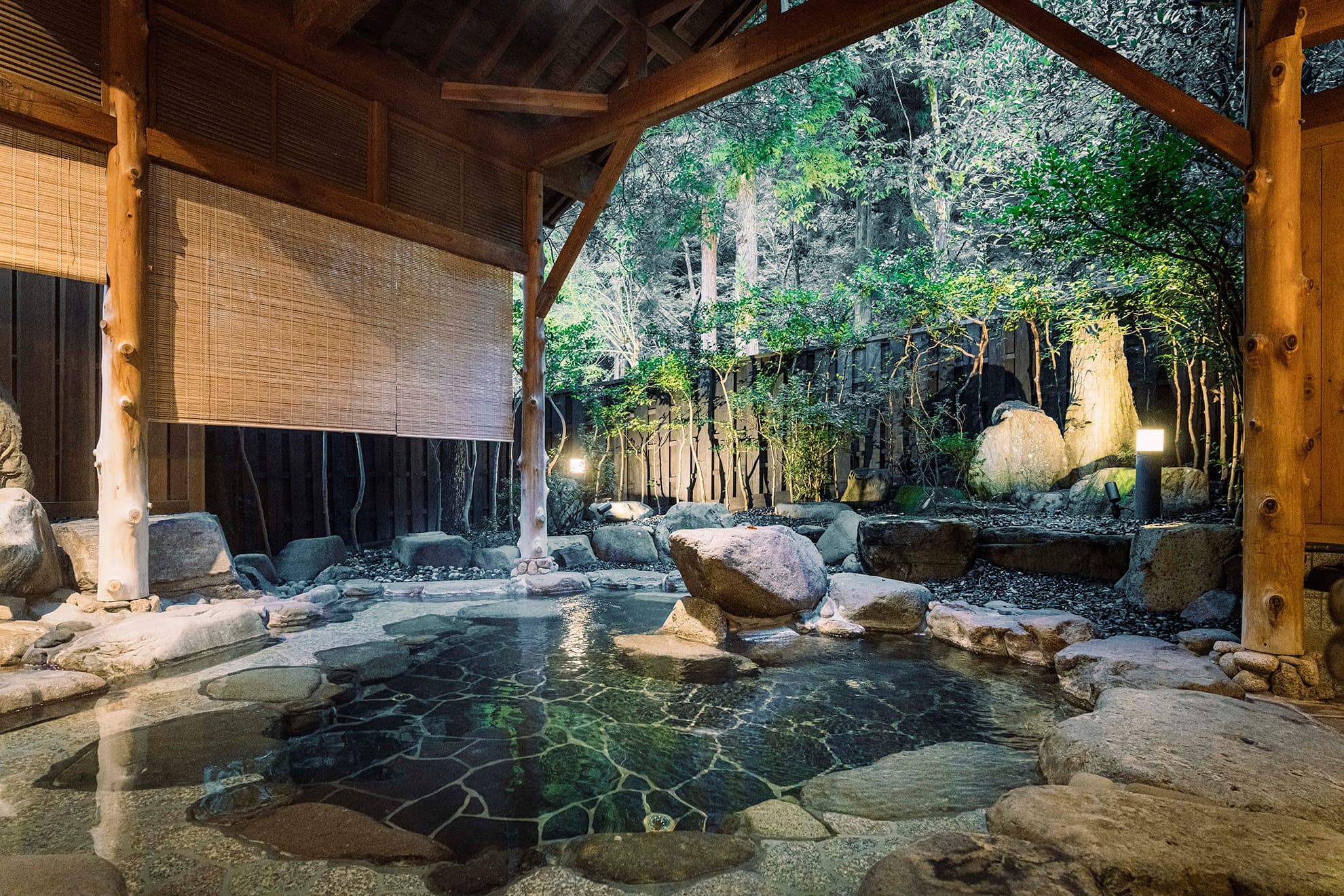 Indoor hot spring bath at Shinzan ryokan with stone and timber finish