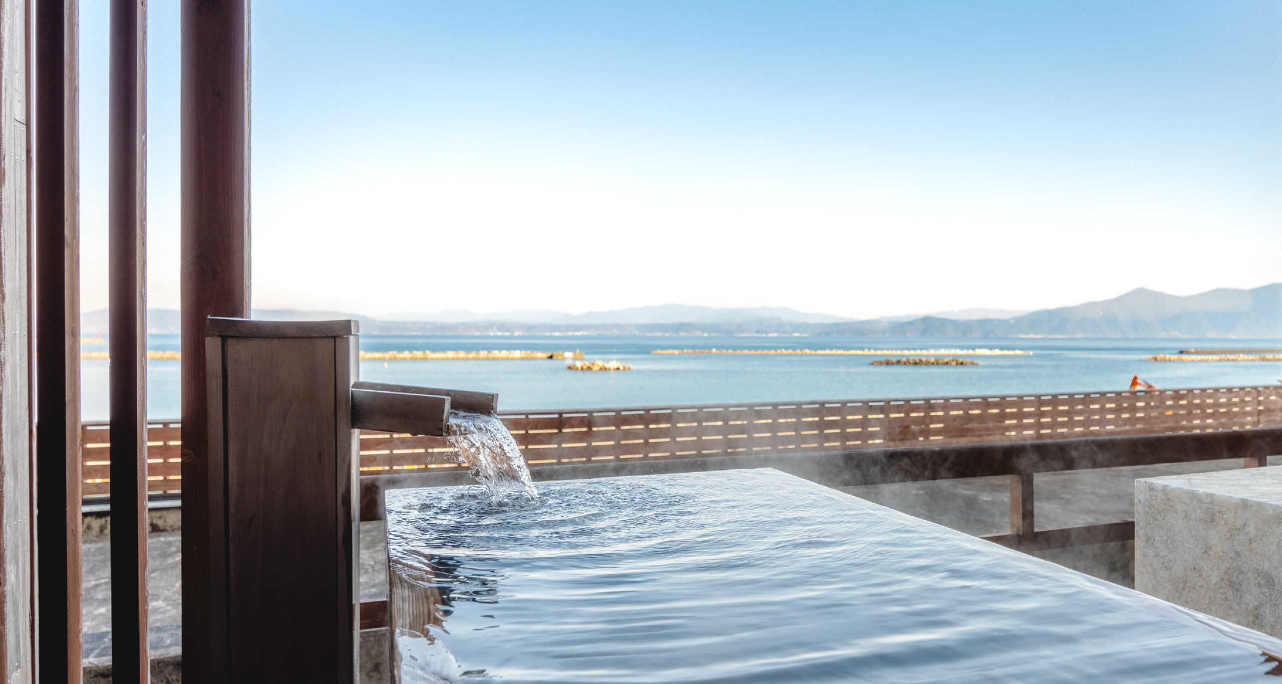 Open-air hot spring bath with daytime panorama of Kinko Bay, Hotel Shougetsu Ibusuki Onsen