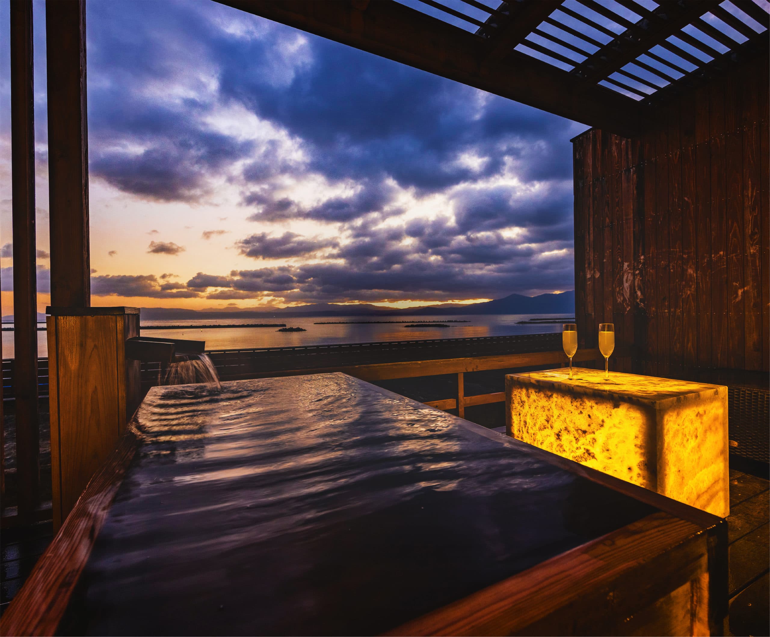 Private open-air rooftop onsen bath at sunset over the bay, Hotel Shougetsu Ibusuki