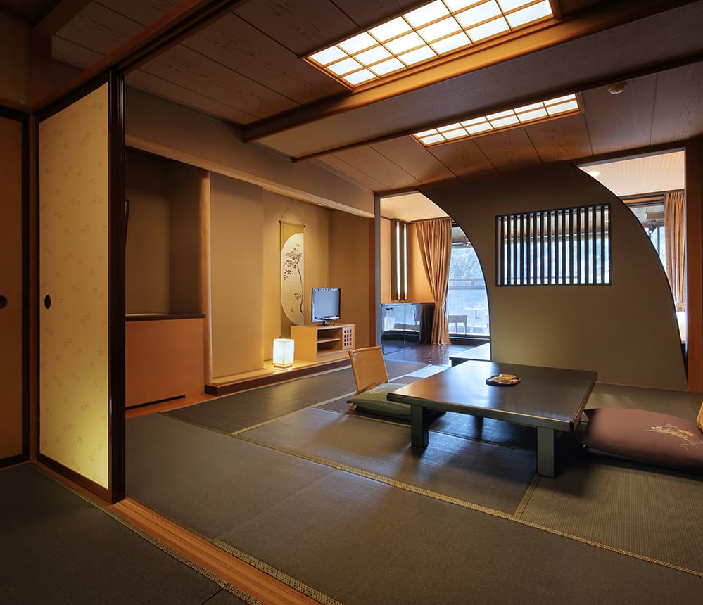 Spacious Japanese-style room with tatami, low table and hanging scroll alcove