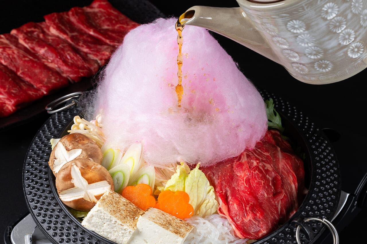 Signature Mt-Fuji-shaped cotton candy hotpot at Hotel Asafuji with beef, tofu and vegetables as broth is poured over