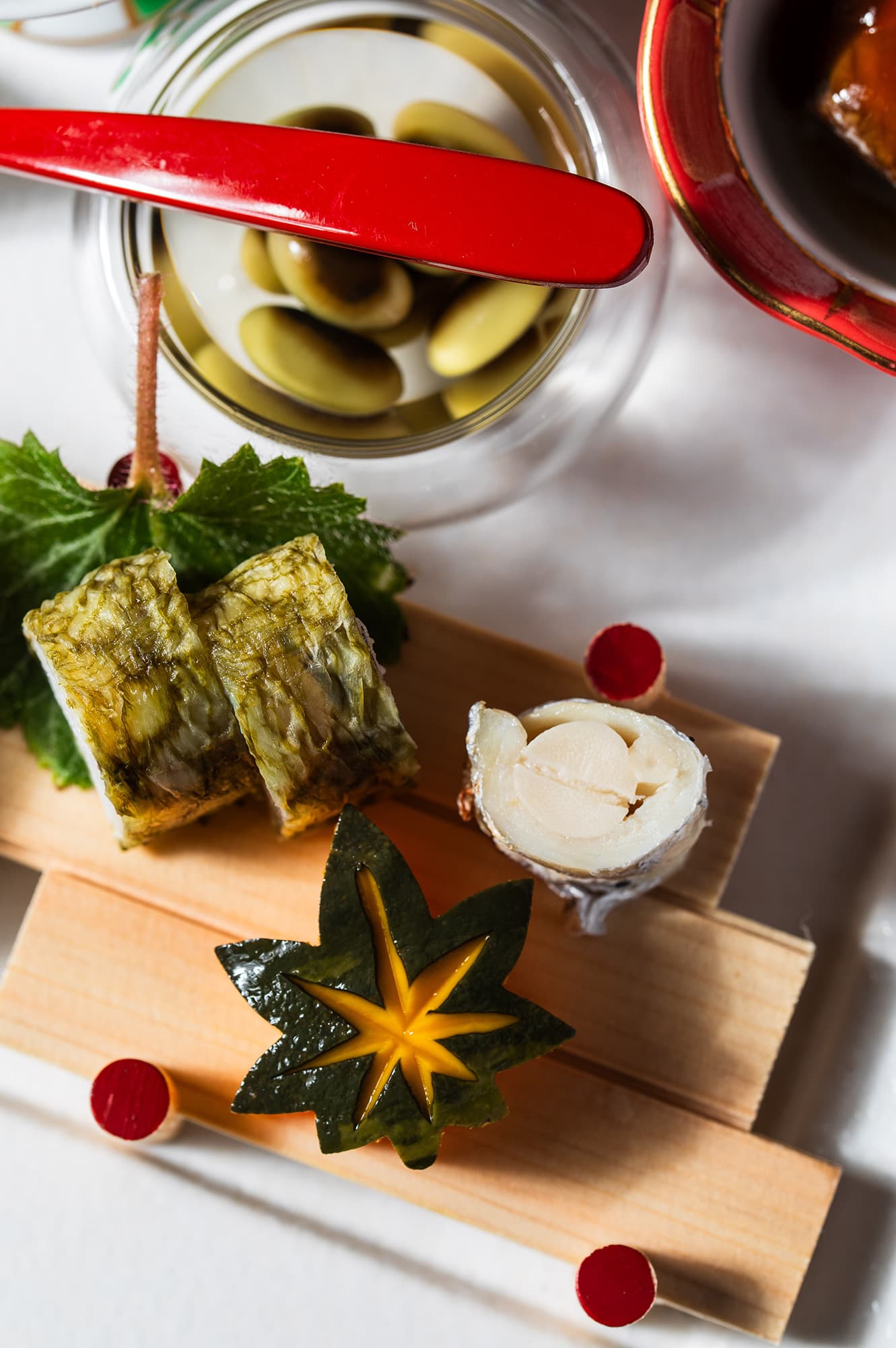 Seasonal kaiseki appetizers at Asebino plated on cedar boards with simmered beans and a maple-cut garnish, Izu