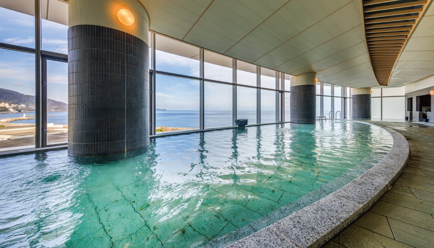 Umi-no-yu indoor public bath with floor-to-ceiling windows overlooking Sagami Bay at Atami