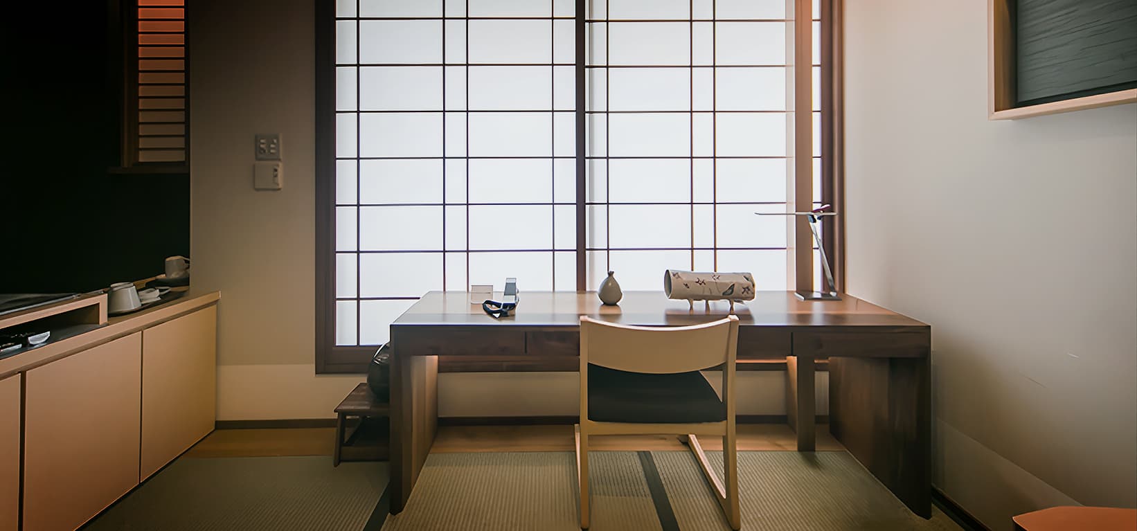 Walnut writing desk set against a shoji-screened window in a tatami study at CHAHARU Hanare Dogo Yumekura
