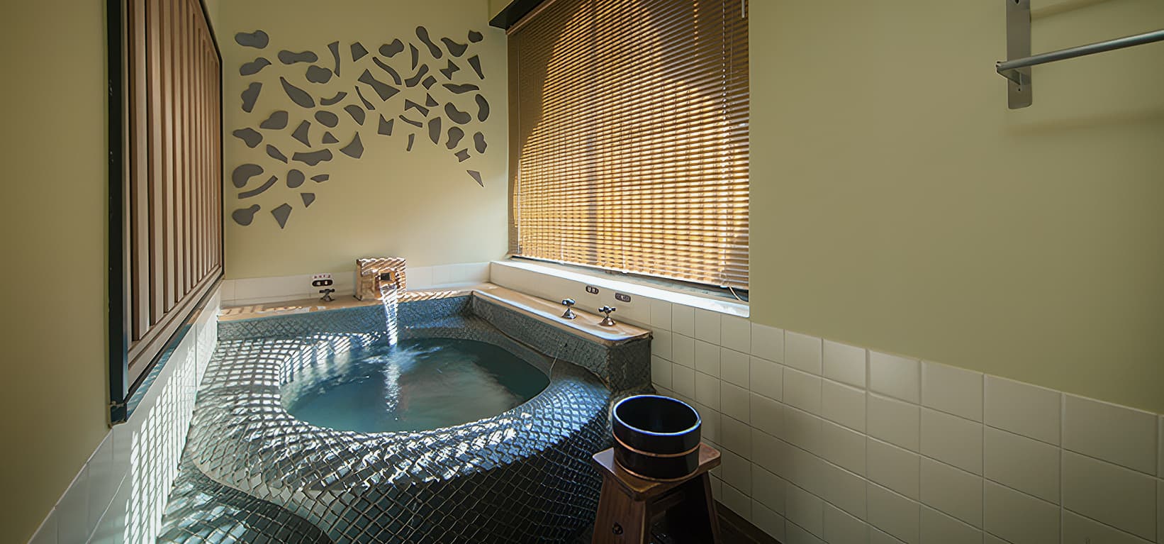 In-room private bath with turquoise tilework and a sunlit window at a Dogo Yumekura villa