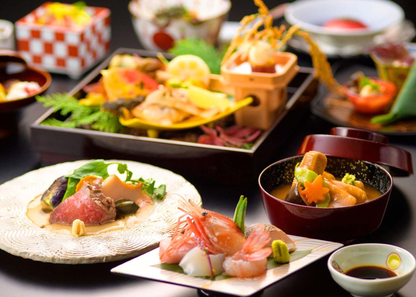 Full kaiseki dinner spread with seasonal seafood, lacquerware and a lidded soup bowl at Ryokan Kanazawa Chaya