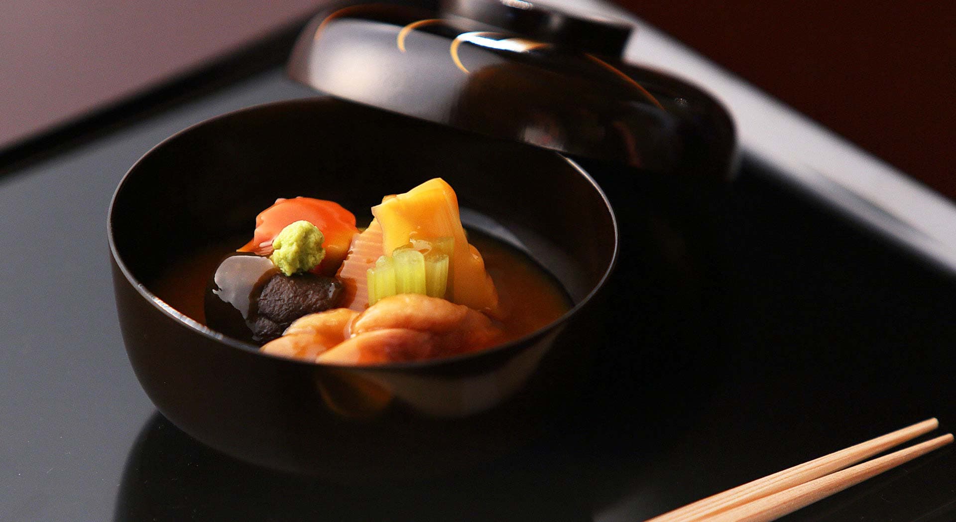 Lidded lacquer soup bowl wanmono course with vegetables and wasabi from the Kanazawa Chaya kaiseki menu