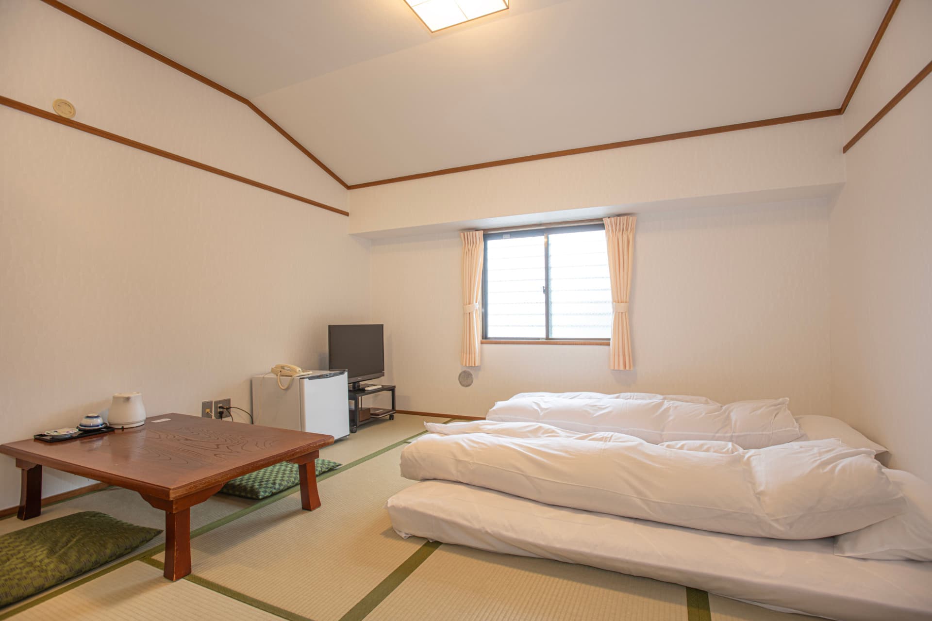 Mountain-side Japanese-style room at Sakuraya with a futon and a low table