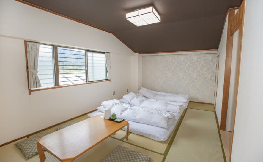 Sea-side Japanese-style room at Sakuraya with futons laid on tatami